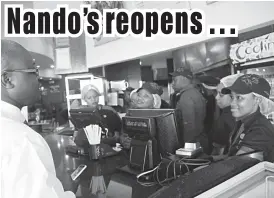  ??  ?? A customer places an order at Nando’s food outlet that reopened its doors to the public in Bulawayo on Tuesday. (Picture by Nkosizile Ndlovu)