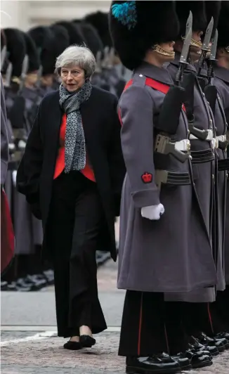  ?? PHOTO: DAN KITWOOD/WPA POOL/GETTY IMAGES ?? Under fire: Theresa May with British army officer major general Benjamin John Bathurst as Japanese Prime Minister Shinzo Abe receives a military guard of honour in London.