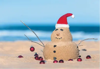  ?? ?? Australian Christmas sandman with decoration on the iconic Bondi Beach in Sydney.