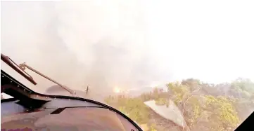  ?? — Reuters photo ?? A helicopter takes off after a rescue made on the fly during the Woolsey Fire in Malibu, California, in this still image taken from helmet camera footage by LAFD David Nordquist.