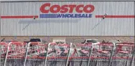  ?? Mario Tama / Getty Images ?? Shopping carts are lined up in front of a Costco store on Thursday in Inglewood, Calif. Costco announced plans to increase its minimum wage to $ 16 per hour.