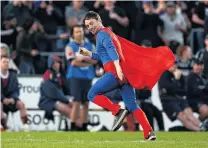  ?? PHOTOS: GETTY IMAGES ?? Heroic? . . . A supporter dressed as Superman runs from the field after helping to tackle the streaker.