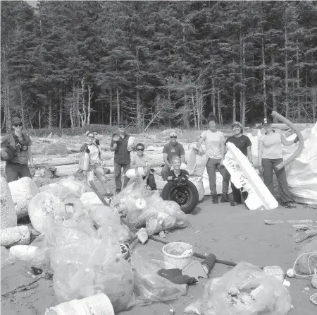  ??  ?? Volunteers clean up trash at Pacific Rim National Park last year. This year, the cleanup party takes place Saturday, Aug. 27, from 9 a.m. to 2 p.m. Meet at the Kwisitis Visitor Centre on Wickaninni­sh Beach.