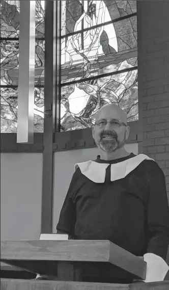  ?? JOHN BAYS/NEWS-SENTINEL ?? St. Peter Lutheran Church's new Pastor Tim Blau stands at the pulpit of his new church in the pilgrim costume he wore to welcome students to the church's school on Friday morning.