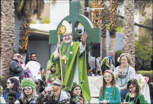 ?? Patrick Connolly Las Vegas Review-Journal @PConnPie ?? St. Patrick waves to spectators Saturday on a float sponsored by the St. Baldrick’s Foundation at the St. Patrick’s Day parade in Henderson’s Water Street District.