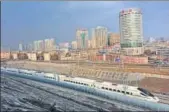  ?? VCG VIA GETTY IMAGES ?? A highspeed train runs across Urumqi, Xinjiang province, during a test run.