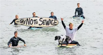  ?? ?? Waves of protest: surfers object to sewage dumping near Bournemout­h