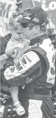  ?? RANDY SARTIN, USA TODAY SPORTS ?? Greg Biffle holds daughter Emma on Father’s Day after winning the Quicken Loans 400 at Michigan Internatio­nal Speedway.