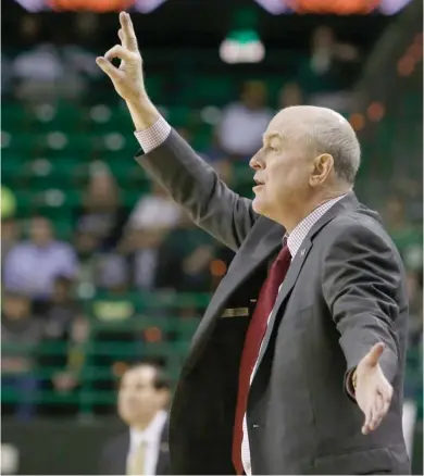  ?? (Photo by Jose Yau, Waco Tribune-Herald, AP) ?? Mississipp­i State men's basketball coach Ben Howland flashes a signal out to his team during last season's National Invitation­al Tournament.