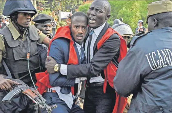  ??  ?? Fear: Students clash with police during a protest against the motion to scrap the presidenti­al age limit — seen as a way for Museveni to seek a sixth term as leader. Photo: Isaac Kasamani/AFP