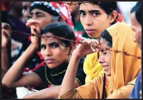  ??  ?? Missing, presumed dead – the depth of despair these three words bring is seen in the faces of these women, who lost a relative in the collapse of Rana Plaza