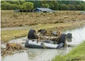  ?? GETTY-AFP ?? A wrecked car lies in a flooded area Thursday near Napier, New Zealand, in the aftermath of Cyclone Gabrielle. The storm was the worst in the history of the country.