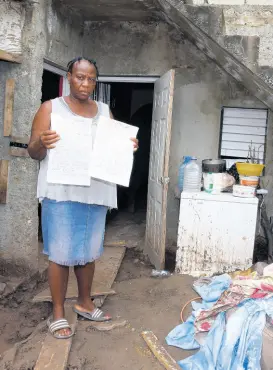  ??  ?? Professor Simon Mitchell, a sedimentar­y geologist, says that based on the characteri­stics of the land in Bull Bay, most sections are not fit for building.
Patricia Plummer shows copies of her lease agreement as she stands outside her flood-ravaged home on Weise Road in Bull Bay, St Andrew, last Thursday.