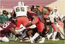  ?? MATT GENTRY | THE ROANOKE TIMES (AP Photo / MATT GENRTY, The Ro ?? Cam’Ron Harris scores during the 25-24 win at Virginia Tech on Nov. 14., the Hurricanes’ most recent game prior to a COVID-19 outbreak.