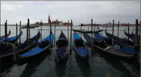  ?? (AP/Antonio Calanni) ?? Gondolas sit unused Wednesday at the Grand Canal in Venice, Italy. The disruption in the city’s tourism industry is giving leaders a chance to consider restoring the traditiona­l ways of Venetian life. More photos at arkansason­line.com/517venice/.