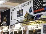  ??  ?? Some of the military and first responder themed items on display around the sign for Front Lines Barbershop at 5 Parkside Drive in Cumru Township.. At Front Lines Barber Shop, a barbershop with a military and first responder theme in Shillingto­n, PA Monday morning March 29, 2021. The shop was opened by two veterans, and offers a 15% discount to military and first responders.