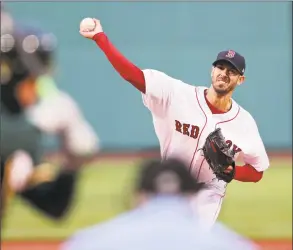  ?? Charles Krupa / Associated Press ?? Red Sox starting pitcher Rick Porcello delivers during the first inning against the Athletics on Tuesday at Fenway Park.