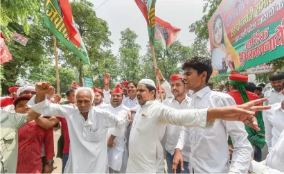  ?? — PTI ?? Samajwadi Party workers celebrate their party’s victory on Noorpur assembly seat, in Lucknow on Thursday. Party leader Akhilesh Yadav said: “This is a defeat for those who do not believe in democracy and play divisive politics.”