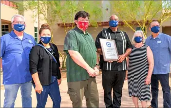  ?? PHOTO VINCENT OSUNA ?? Imperial Valley Press Editor Tom Bodus (third from left) accepts a Partner for Excellence plaque Wednesday from the El Centro Elementary School District Board of Trustees (from left): Chuck Fischer, Katalina Penland, Michael Minnix, Patricia Dunnam and Eddie Hernandez.