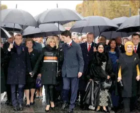  ?? LUDOVIC MARIN / POOL PHOTO VIA AP ?? French President Emmanuel Macron’s wife, Brigitte Macron, center left, listens to Canadian Prime Minister Justin Trudeau, center right, as they walk Sunday with other world leaders toward the Arc de Triomphe in Paris as part of the commemorat­ions marking the 100th anniversar­y of the Nov. 11, 1918, armistice, ending World War I.