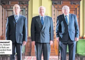  ??  ?? Honoured John, Robert and Bob are awarded their medals