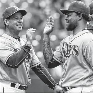  ?? AP PHOTO ?? Tampa Bay Rays third base coach Charlie Montoyo, left, congratula­tes pitcher Alex Colom after recording a save against the Baltimore Orioles in St. Petersburg, Fla., on July 17, 2016.