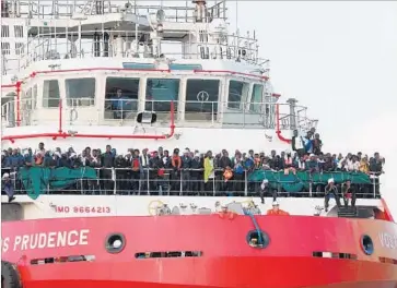  ?? Carlo Hermann AFP/Getty Images ?? A SHIP run by Doctors Without Borders arrives in Salerno, Italy, with 935 people recovered from the sea.