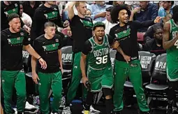  ?? REBECCA BLACKWELL / AP ?? Boston Celtics players cheer during the second half of Game 4 during the NBA basketball playoffs Eastern Conference finals against the Miami Heat on Tuesday.
