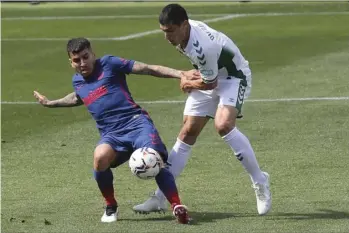  ?? AP PHOTO/ALBERTO SAIZ ?? Atletico Madrid’s Angel Correa (left) vies for the ball against Elche’s Diego Gonzalez during the Spanish La Liga soccer match between Valencia and Atletico Madrid at the Mestalla stadium in Valencia, Spain, on Saturday.