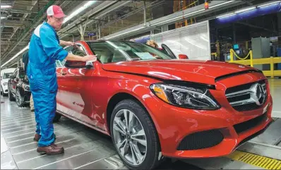  ?? AFP ?? An employee conducts final inspection­s on a Mercedes-Benz C-Class at the Mercedes-Benz US Internatio­nal factory in Vance, Alabama.