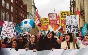  ?? AFP PIC ?? Teachers taking part in a protest in London on Wednesday. Children missed school and commuters faced severe disruption in the UK as half a million workers staged walkouts calling for higher wages in the largest such strikes in over a decade.