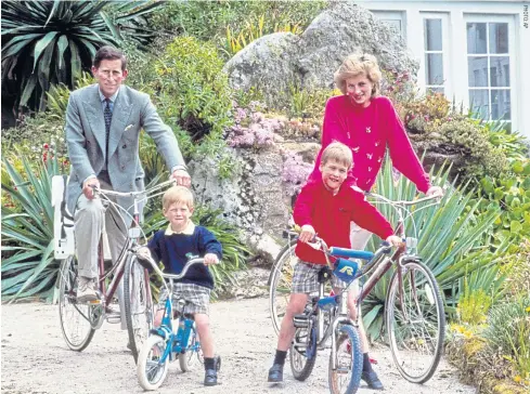  ??  ?? Britain’s Prince Charles and Princess Diana and their sons, Princes William, right, and Harry begin a cycle ride around the island of Tresco, one of the Scilly Isles, England.