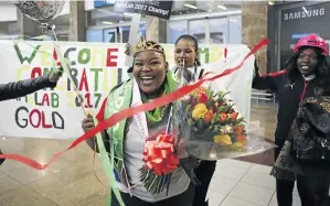  ?? / ALAISTER RUSSELL ?? Geologist Tshiamo Legoale is welcomed back home by friends and family at OR Tambo Internatio­nal Airport.