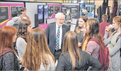  ?? DAVID JALA/CAPE BRETON POST ?? Dr. Art McDonald, a Sydney native who won the 2015 Nobel Prize in Physics, holds court with a group of high school students from New Waterford’s Breton Education Centre on Monday at a scientific exhibition at Cape Breton University. McDonald also gave...