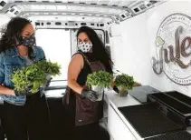  ?? Melissa Phillip / Staff photograph­er ?? Julep bar owner Alba Huerta, right, with employee Andrea Irving, added a cocktail delivery truck to survive the shutdown.