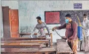  ??  ?? Workers sanitize a classroom at a school ahead of its reopening from February 12 in Nadia on Thursday