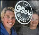  ?? HELEN H. RICHARDSON — THE DENVER POST ?? Owners Miranda Spencer, left, and Annie Weaver, right, pose for a portrait behind the logo at their new, soon-to-be opened bar The 99ers Sports Bar in Denver on April 16.