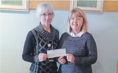  ??  ?? Golden K member Debbie Stevens, left, presents a cheque for $3,500 to Debbie Madore, right, the Nutrition For Learning Dietician for the Cape Breton Victoria Regional School Board, in support of their school breakfast program. 46#.*55&% 1)050