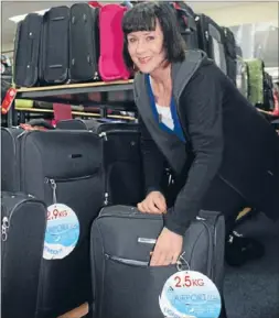  ?? Photo: LIBBY
O’BRIEN ?? ON HER WAY: Irene Docherty gets a travel bag sorted for her upcoming trip to the Olympics to support her son, former Olympic medallist and London hopeful Bevan Docherty.