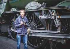  ??  ?? Below: Michael Topham stands next to the Flying Scotsman with the camera he chose to shoot with – Fujifilm’s medium format GFX 50S