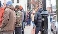  ?? KATHLEEN GALLIGAN/DFP ?? Crowds wrap around the corner of E. Liberty and S. Division streets to get into Arbors Wellness on the first day of legal marijuana sales in Ann Arbor on Dec. 1.