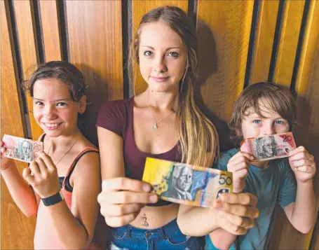  ?? Picture: MICHAEL FRANCHI ?? Catherine, Ailish and Flynn Tilbrook prefer to get money for Christmas instead of presents