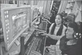  ?? CHAI SHIJUE / FOR CHINA DAILY ?? People play online games in an internet bar in Qingdao, Shandong province.