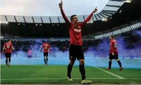  ?? Photograph: Tom Jenkins/The Guardian ?? Robin van Persie celebrates his 90th-minute winner against Manchester City on 9 December 2012.