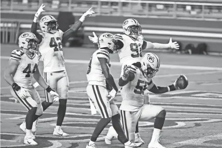  ?? GETTY IMAGES ?? Packers linebacker Za'Darius Smith celebrates with teammates after forcing a turnover against the 49ers last Thursday. It's one of the few times this season the Packers have had something to be pleased about on defense.