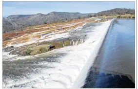  ?? CONTRIBUTE­D BY KELLY M. GROW / CALIFORNIA DEPARTMENT OF WATER RESOURCES ?? Water from the Oroville Dam Auxiliary Spillway at Lake Oroville flows toward a diversion pool Sunday in Oroville, California. Butte County Sheriff Kory Honea did not say how long the spillway fixes could take and offered no timetable for lifting the...