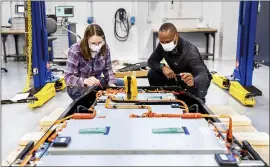  ?? FORD VIA THE ASSOCIATED PRESS ?? Mary Fredrick, a Ford battery validation engineer, and Dane Hardware, a design and release engineer, measure the voltage of a battery using a digital multi-meter at Ford’s Battery Benchmarki­ng and Test Laboratory in Allen Park, Mich.