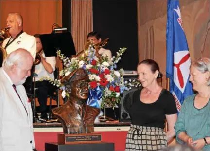  ?? MARIAN DENNIS– DIGITAL FIRST MEDIA ?? On left, sculptor Jerry McKenna helps unveil his bronze sculpture of Gen. Carl Spaatz. Katharine Gresham and Ruth Thomas, Spaatz’s granddaugh­ters, right, admire the work as it is revealed publicly for the first time.