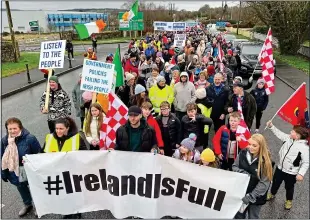  ?? ?? angry: Protesters waving Roscrea GAA club flags and signs this week as they protest against plans to house 160 asylum seekers at the Racket Hall Hotel