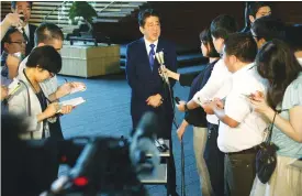  ?? (AFP) ?? Japan’s Prime Minister Shinzo Abe (centre) at his official residence in Tokyo on Friday